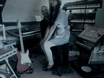 Jean Devalive sitting on Paul Zawadzki knee in recording studio blue grey image 